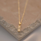 18k Gold Filled material and featuring a delicate 1.45mm width along with a charming moon bar pendant